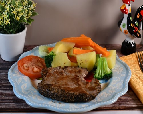 Grilled salmon steak served with vegetables rich in healthy nutrients