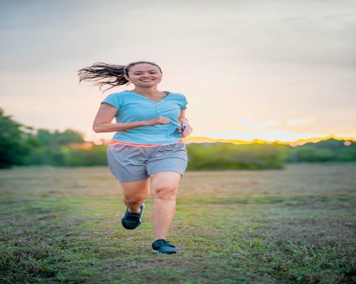 Person running at sunset emphasizing consistency in a healthy active lifestyle
